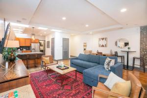 a living room with a blue couch and a table at Spacious Penthouse ON the Broadway Strip in Nashville