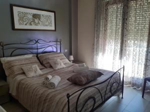 a bedroom with a large bed with towels on it at casa Lorena in Frosinone