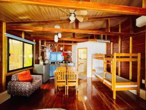a living room with a couch and a kitchen at Chue&larry's Beachside Homestay in Libagon +46 photos