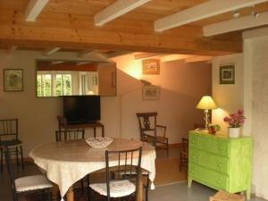 a kitchen and dining room with a table and chairs at Ronsard in Bonnes