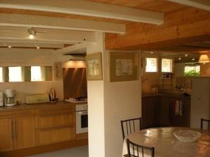 a kitchen and dining room with a table and chairs at Ronsard in Bonnes