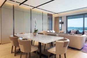 a dining room with a white table and chairs at JW Marriott Hotel Istanbul Marmara Sea in Istanbul