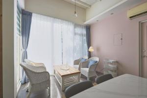 a room with chairs and a table and a window at OwlStay Green Villa in Pinghe +40 photos