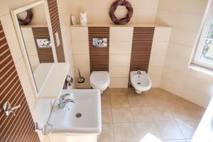 a small bathroom with a sink and a toilet at Laguna Resort in Budzisław