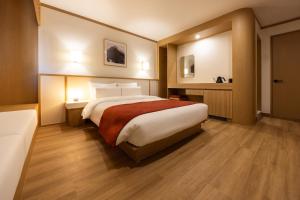 Postel nebo postele na pokoji v ubytování AanK Hotel & Spa Pyeongtaek
