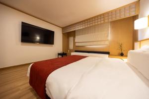 Postel nebo postele na pokoji v ubytování AanK Hotel & Spa Pyeongtaek