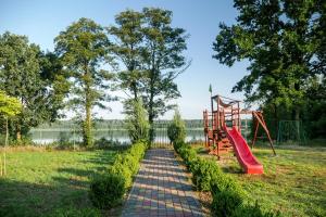 a path with a playground and a slide at Laguna Resort in Budzisław
