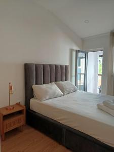 a bedroom with a large bed with a headboard at Casa Além Da Ponte in Vouzela +35 photos