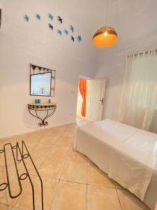 a bedroom with a bed and birds on the wall at Dar Rita in Houmt Souk