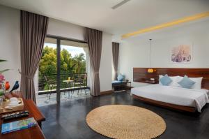 a bedroom with a large bed and a balcony at Khmer House Boutique in Siem Reap