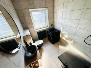an overhead view of a bathroom with a toilet and a sink at Casa del Sol - Ferienwohnung Norddeich in Norddeich +33 photos