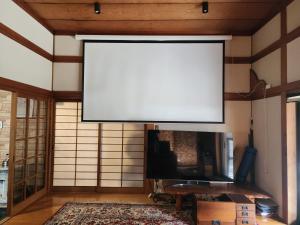 a large white screen on the wall of a room at Samurai House! Seen in Movies and Dramas near HIKOSAN !! in Soida