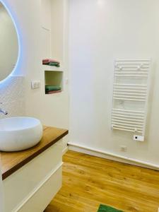 a bathroom with a white sink on a wooden counter at Maison à Cholet in Cholet