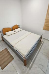 a bed in a room with a white wall at Dora in Posušje