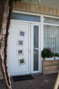 a white garage door with pictures on it at Dora in Posušje