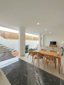 a living room with a wooden table and chairs at FREE airport pickup for new 2BR villa near Canggu in Sangeh
