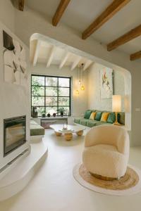 a living room with a television and a chair at Heretat de Sant joan in Ferreries