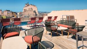 a group of chairs and tables on a deck at Grand H&ocirc;tel Dauphin&eacute;, Boutique H&ocirc;tel & Suites in Toulon