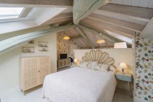 1 dormitorio con 1 cama blanca en el ático en Apartamentos Boutique Casa Cigarrán, en Vegadeo 211 fotos más
