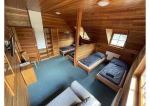 an overhead view of a room with two beds and a couch at Areál Kamínka - POKOJE A APARTMÁNY in Roštín