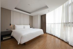 Postel nebo postele na pokoji v ubytování Atour Hotel Guangzhou Yueqiao Branch