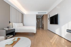 TV a/nebo společenská místnost v ubytování Atour Hotel Guangzhou Yueqiao Branch