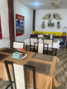 a dining room with tables and chairs in a restaurant at Vang Vieng Victory Hostel in Vang Vieng