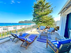 a patio with blue chairs and a table and chairs at Il Profumo del Mare GuestHouse in Cagliari +70 photos