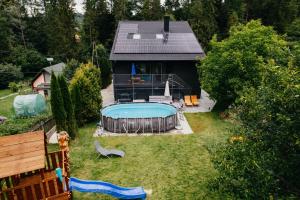 an overhead view of a house with a swimming pool at Willa Czaremka - sauna, basen, kino, bilard, bawialnia in Ujsoły
