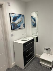 a bathroom with a sink and two mirrors at Fully ensuite room in Hull +10 photos