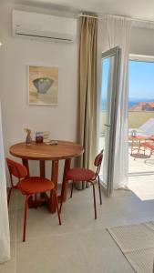 a dining room with a table and chairs and a balcony at Lukenda Rooms - Boutique Apartments with view of Adriatic Sea in Pakoštane +19 photos
