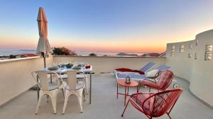 a patio with a table and chairs on a balcony at Lukenda Rooms - Boutique Apartments with view of Adriatic Sea in Pakoštane