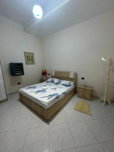 a bedroom with a bed and a tv in it at Vacation Apartments in Hamallaj in Armath +22 photos