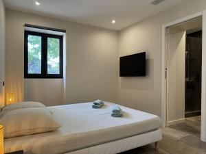 Ένα ή περισσότερα κρεβάτια σε δωμάτιο στο L'Appartement Olivier