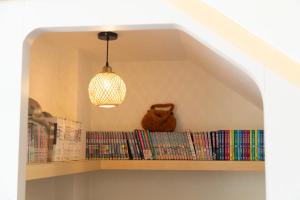 a book shelf with books and a pendant light at 謐之境 l 海景包棟民宿 in Xiaoliuqiu +23 photos