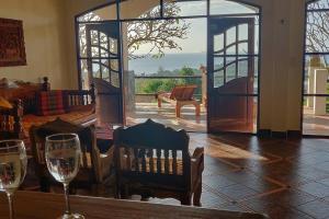 a room with two wine glasses and an open door at Spacious Villa with Sunset Sea View in Phra Ae beach