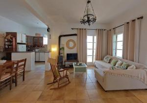 a living room with a couch and a table at Poros Pine View in Poros