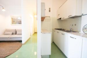two views of a kitchen and a living room at Cinefestival Emerald Suite in Venice-Lido