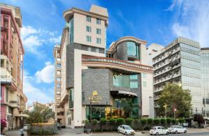a building with cars parked in front of it at Vesta International in Jaipur