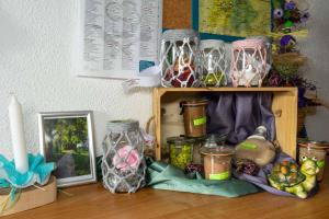 a shelf with jars and a picture and a candle at Ferienwohnung Hofer in Spalt +10 photos
