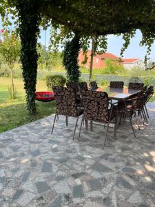 a table and chairs on a patio under an umbrella at Kuća za odmor Matan in Čapljina