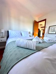 a large bedroom with two beds with pillows on it at Casa da Ribeira - Arouca in Lázaro
