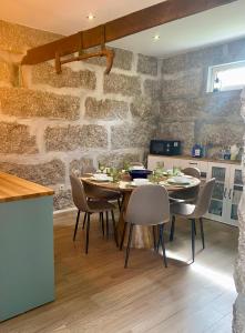 a dining room with a table and chairs at Casa da Ribeira - Arouca in Lázaro