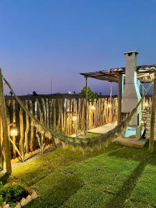 a hammock in a yard next to a fence at Villa Careca in Luis Correia