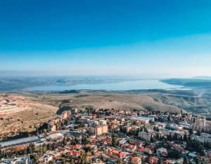 uma vista aérea de uma cidade e de uma massa de água em קונפיטה - וילה מהממת עם בריכה מחוממת מקורה בעיר העתיקה צפת em Safed