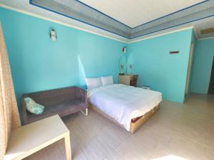 Postel nebo postele na pokoji v ubytování 大潭山莊 Da Tan Mountain INN