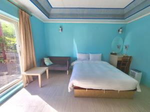 Postel nebo postele na pokoji v ubytování 大潭山莊 Da Tan Mountain INN
