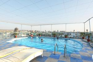 a swimming pool on the roof of a building at Vesta Maurya Palace in Jaipur