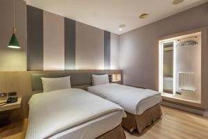 Postel nebo postele na pokoji v ubytování Fu Hsiang Hotel + 35 fotografií