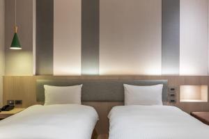 Postel nebo postele na pokoji v ubytování Fu Hsiang Hotel